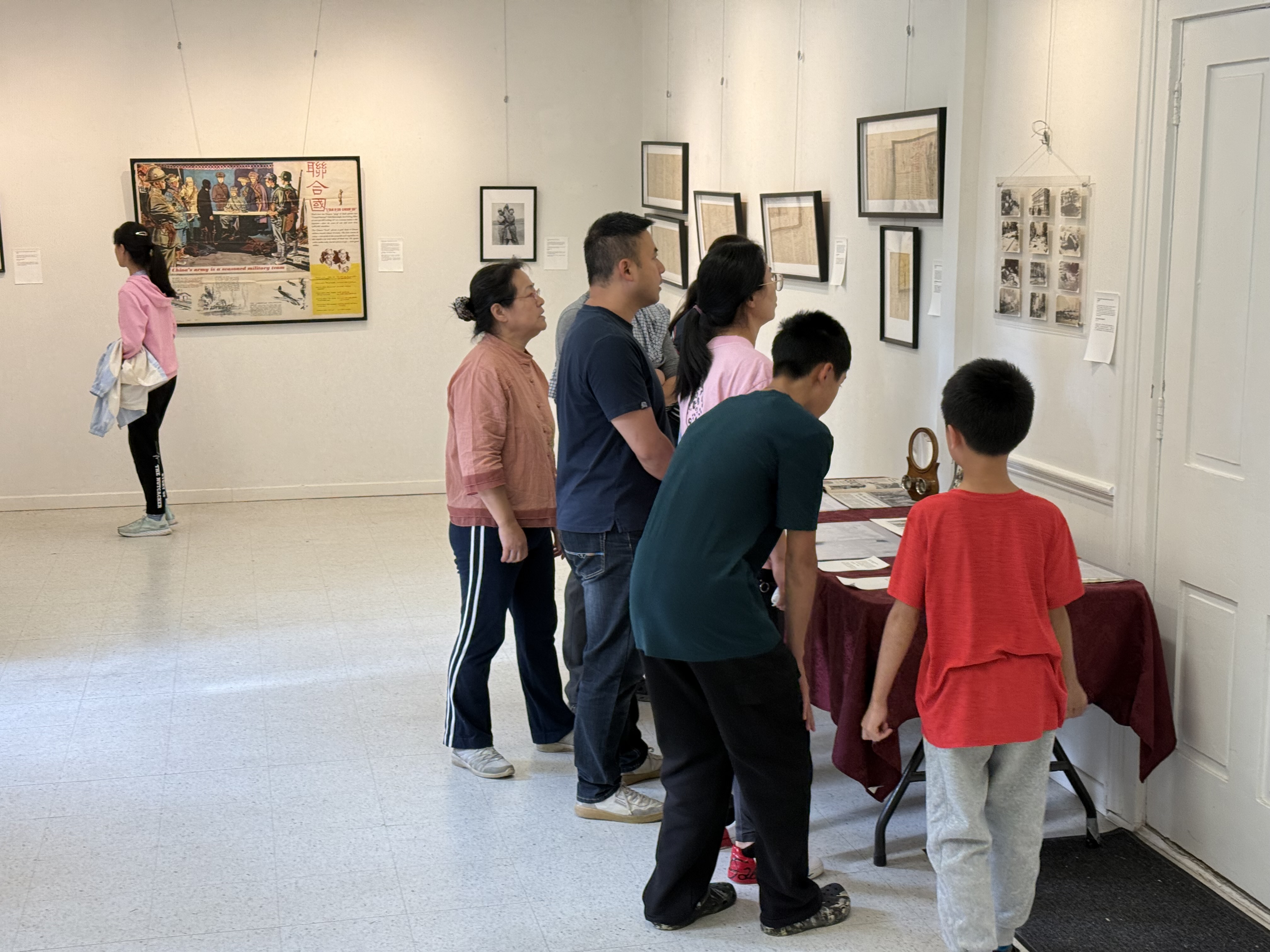 Visitors viewing MOFER exhibition materials together.